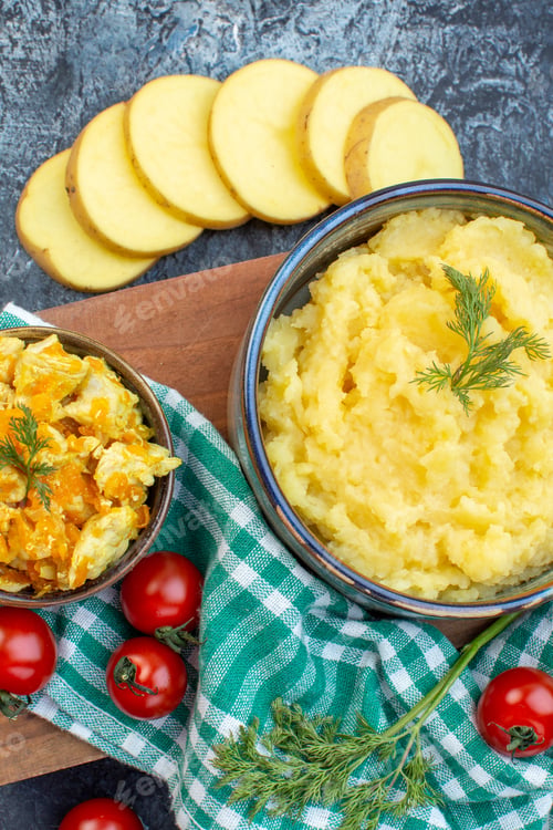 Preview: Top view of mashed potatoes served with dill and delicious dish fresh vegetables on green stripped