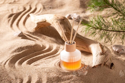 Preview: Wonderful fragrance diffuser in translucent glass bottle on beach.
