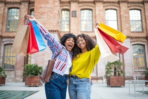 Preview: Happy young women enjoying city shopping together