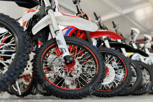 Preview: There are many colorful motorcycles for sale in the exhibition hall. Wheels close-up.