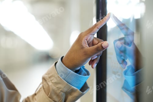 Preview: Focus on hand of young African American woman pointing at display