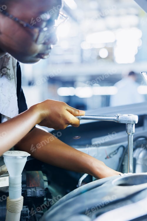 Preview: Worker fixes car helped by lamp light