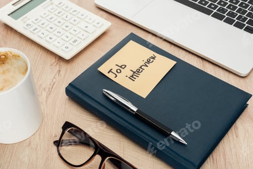 Preview: flat lay with notebook with job view lettering on sticky note on wooden table with laptop,