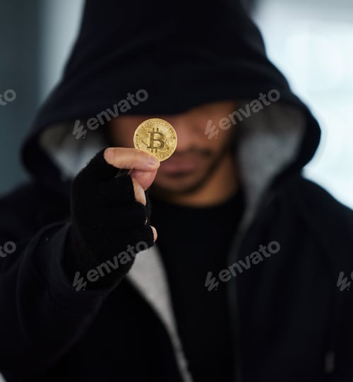 Preview: No digital print will be left behind. Shot of a scammer holding a bitcoin.