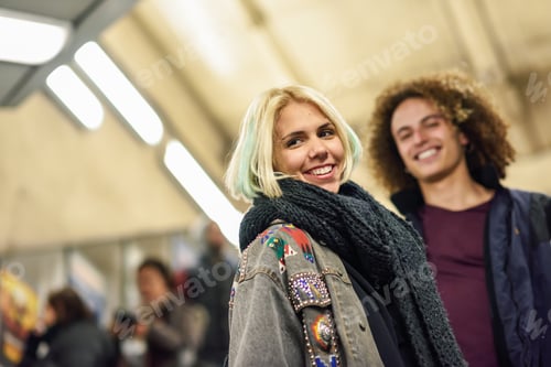 Preview: Young couple going upstairs at a subway station.