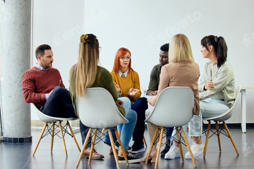 Preview: Group of People Engaged in Discussion During a Casual Meeting in Bright Room