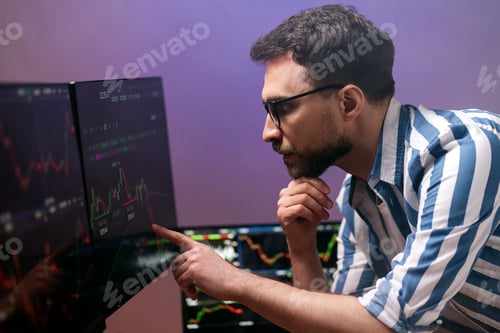 Preview: Trader looking at computer monitor, working online with crypto chart. Broker research stock market