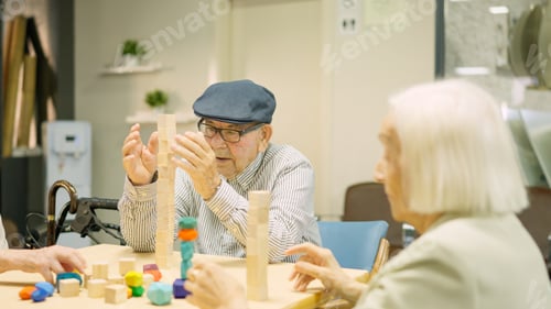 Preview: Man building a tower as skill games in a geriatric