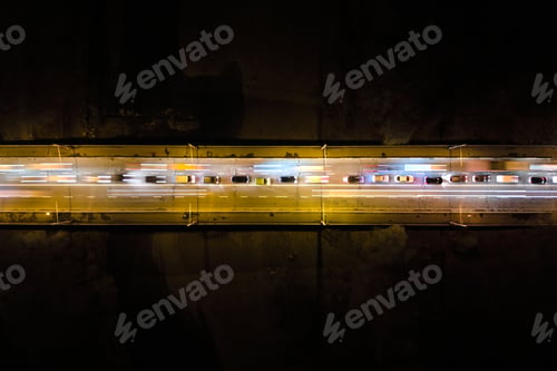 Preview: Aerial view of road with fast moving heavy traffic at night. Top view of urban transportation.