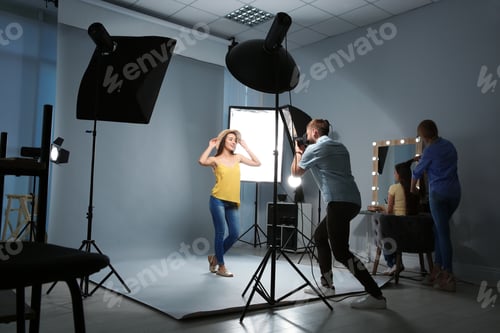 Preview: Beautiful model posing for professional photographer in studio