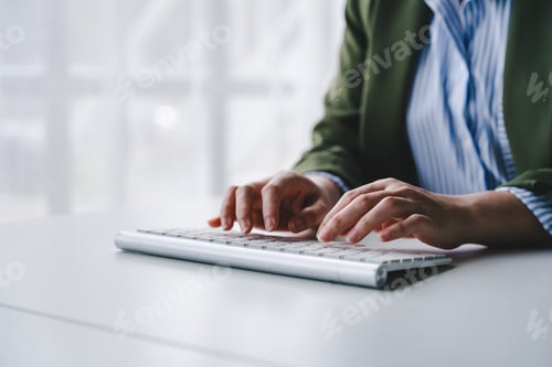 Preview: Typing on keyboard Working online on laptop computer On a white table at the office. Facebook chat.