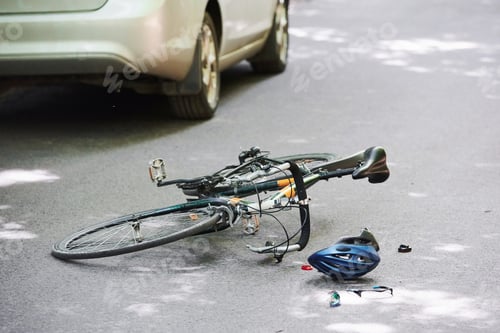 Preview: Drunk driving. Bicycle and silver colored car accident on the road at forest at daytime