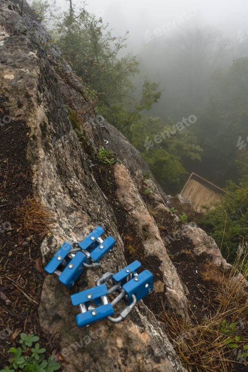 Preview: Rock climbing mount on a stone against a gray sky background close-up