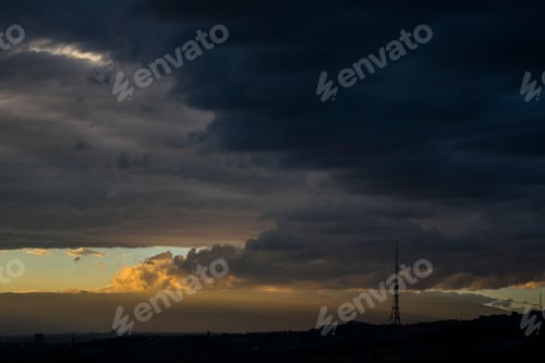 Preview: Sunrise in the city with rainy clouds