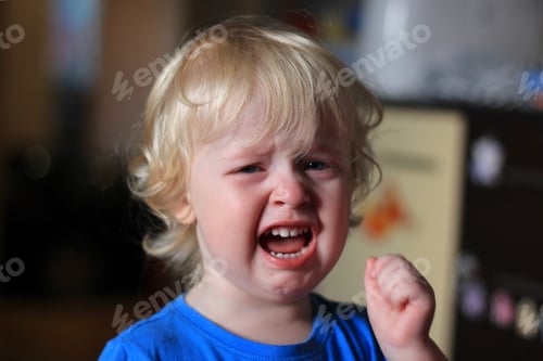 Preview: Portrait of a crying boy. Kid with sad expression. Emotions on the face of baby.