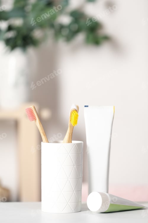 Preview: Bamboo toothbrushes and paste on light table indoors