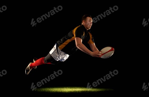 Preview: Rugby player diving an throwing ball