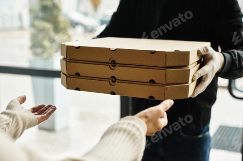 Preview: Delivery man carries food orders to an office at lunch time