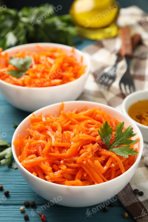 Preview: Composition with tasty carrot salad on wooden background. Korean carrot