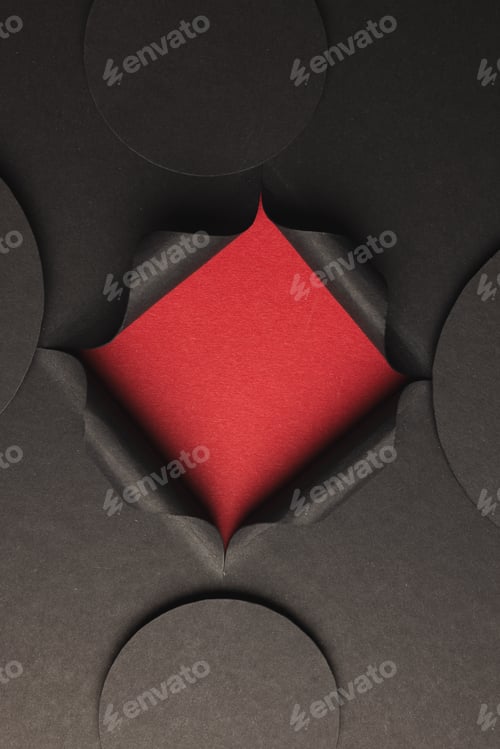 Preview: Vertical image of circles of black paper with copy space and square opening on red background