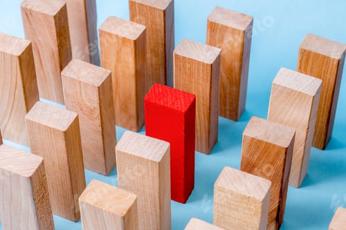 Preview: One Red Wooden Block Stands Out Among Many Natural Wood Blocks, Symbolizing Uniqueness