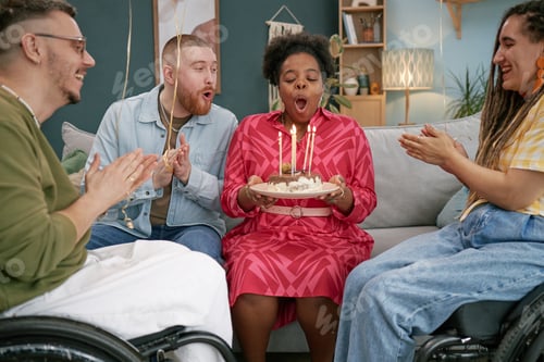 Preview: Multiethnic Young Adults in Wheelchairs Celebrating Birthday Together Indoors