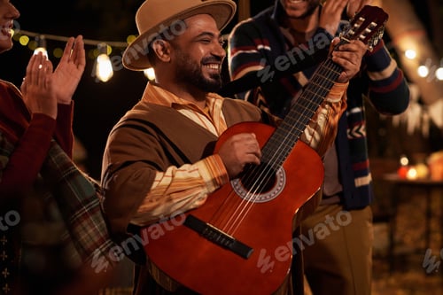 Preview: Happy man playing guitar at holiday