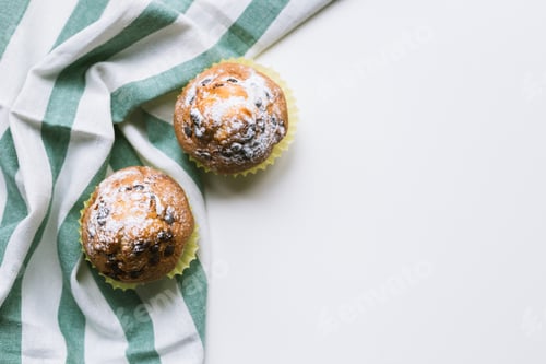 Preview: Two Chocolate Chip Muffins on Striped Kitchen Towel