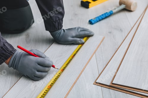 Preview: Worker installing new laminated wooden floor