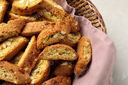 Preview: Traditional Italian almond biscuits (Cantucci) in basket on table, closeup