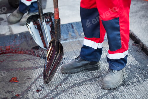 Preview: Repair of roads, highways and sidewalks. Patching. Working with a shovel falls asleep in the pit