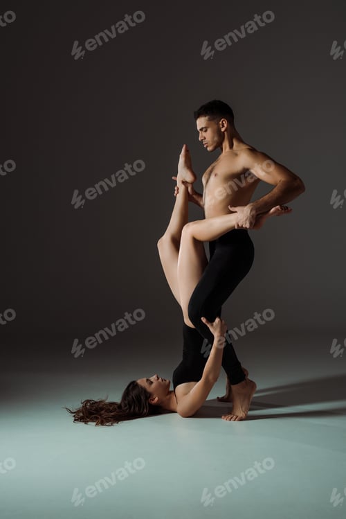 Preview: sexy dancers dancing contemporary on dark background with copy space