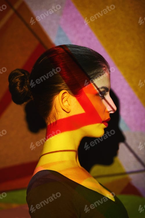 Preview: A beautiful model in the studio covered with a myriad of abstract lighting
