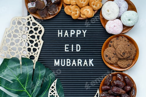 Preview: Assortment Cookies With Dates Fruit On Wooden Plate Surrounding On Happy Eid Mubarak On Letter Board