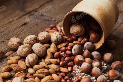 Preview: Selection of Assorted Nuts Spilled From Wooden Bowl