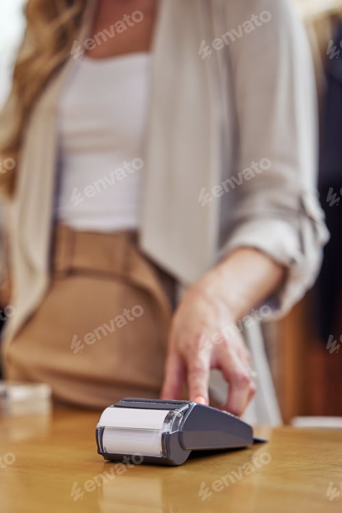 Preview: Shot of a woman using her bank card to pay for a purchase in a store