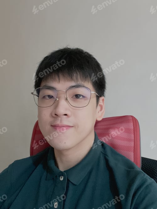 Preview: Young Man Wearing Glasses and Green Shirt Smiling