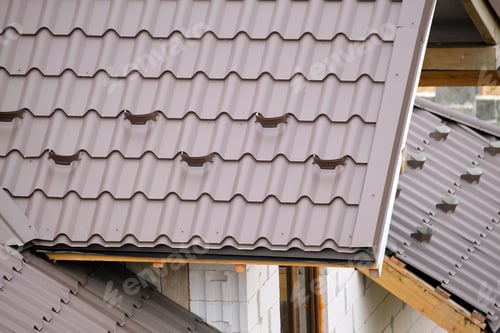 Preview: Closeup snow guard for safety in winter on house roof top covered with steel shingles. Tiled