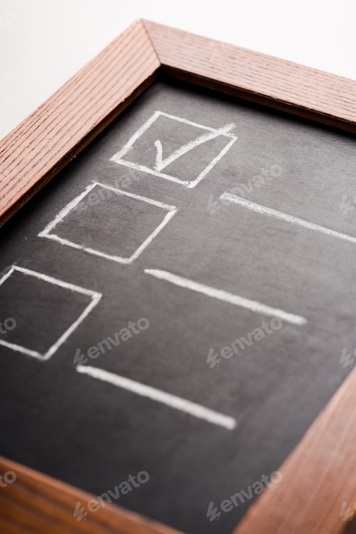 Preview: close up of chalk board with check mark isolated on white