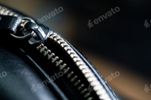 Preview: Close-up of metallic zipper on black leather
