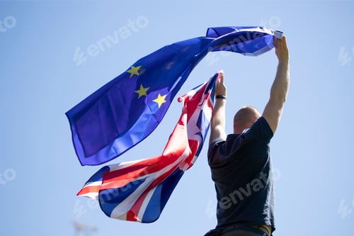 Preview: UK England Flag and European Union EU Flag holded by a man.
