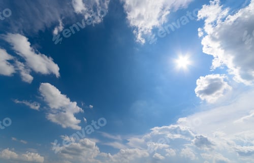 Preview: Blue sky with fluffy clouds and sun