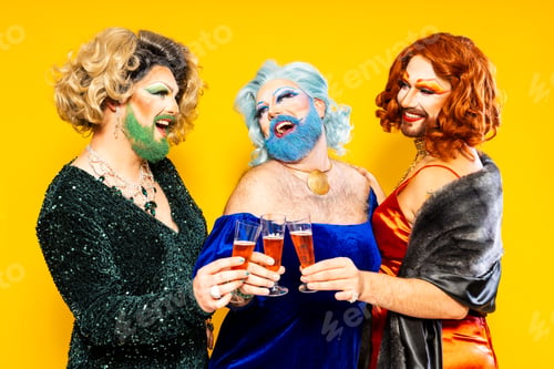 Preview: Happy drag queens toasting champagne glasses