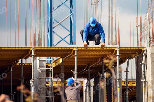 Preview: Real Construction Worker Working On A High Building And Leveling Floor For Cementing.
