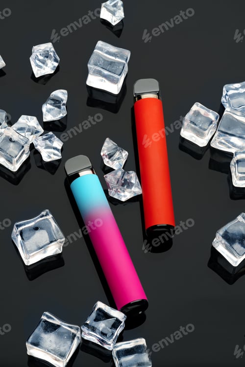 Preview: Disposable electronic cigarettes with ice cubes on black background