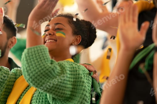 Preview: Brazilian young football fans supporting their team at stadium.