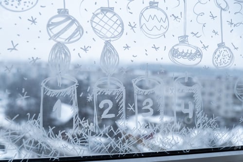 Preview: Sustainable responsible holiday decor. Christmas advent candle painted on window glass indoor at