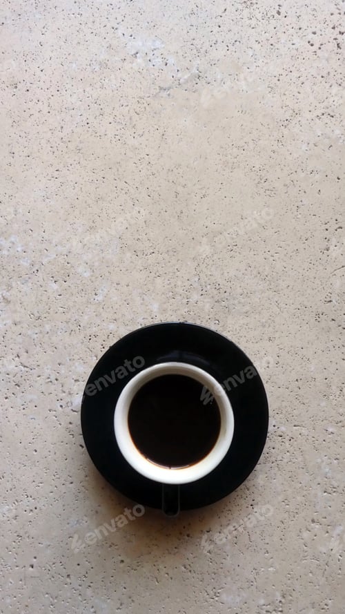 Preview: cup of coffee on stone table with space for text
