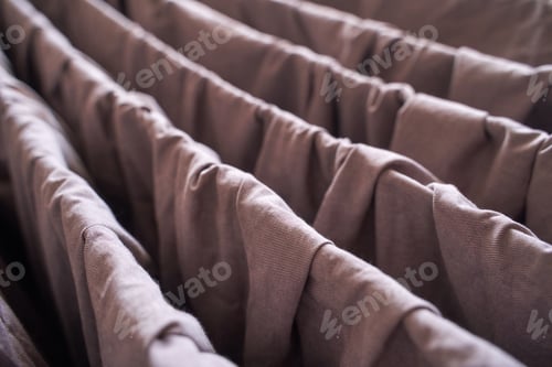 Preview: Close up of brown fabric folds with textured surface and soft creases in natural
