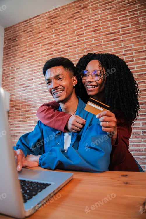 Preview: Vertical. African American couple is using a laptop to search a sale on a online shop. Excited